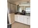 Clean bathroom featuring a walk-in shower, double sinks, and plenty of counter space for organization at 2663 Brookside Bluff Loop, Lakeland, FL 33813