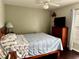 Bedroom featuring a ceiling fan, dresser, and hardwood floors at 2663 Brookside Bluff Loop, Lakeland, FL 33813