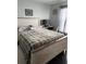 Calming bedroom with a wood-frame bed, a plaid comforter, and a coastal-themed decor at 2663 Brookside Bluff Loop, Lakeland, FL 33813