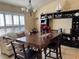 Bright dining room featuring a wooden table, dark accents, and display shelving for added character at 2663 Brookside Bluff Loop, Lakeland, FL 33813