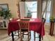 Inviting dining area with a red tablecloth, seating for four, and views from the windows at 2663 Brookside Bluff Loop, Lakeland, FL 33813
