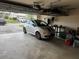 Bright garage with overhead storage, compact silver car and epoxy floor at 2663 Brookside Bluff Loop, Lakeland, FL 33813