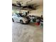Spacious garage with overhead storage and a compact silver car with blue racing stripes at 2663 Brookside Bluff Loop, Lakeland, FL 33813