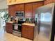 Modern kitchen featuring stainless steel appliances, granite counters, and ample wood cabinets at 2663 Brookside Bluff Loop, Lakeland, FL 33813