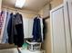 Laundry room with hanging clothes, overhead storage, and a front-load washer and dryer at 2663 Brookside Bluff Loop, Lakeland, FL 33813