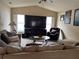 Cozy living room with plush seating, a large TV, and plenty of natural light from the windows at 2663 Brookside Bluff Loop, Lakeland, FL 33813