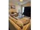 Comfortable living room featuring a sectional sofa, a glass coffee table, and a large flat-screen TV at 2663 Brookside Bluff Loop, Lakeland, FL 33813