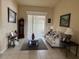 Inviting living room with neutral paint, tile floors, comfortable sofa, and views to the outdoor space at 2663 Brookside Bluff Loop, Lakeland, FL 33813