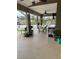 Covered patio with ceiling fans, table with chairs, potted plants, and tv at 2663 Brookside Bluff Loop, Lakeland, FL 33813