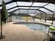 Backyard pool surrounded by a screened-in enclosure and white vinyl fence at 2663 Brookside Bluff Loop, Lakeland, FL 33813