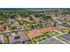 This aerial view shows the residential area with mature trees and a lake nearby, and manicured lawns at 2743 Verandah Vue Way, Lakeland, FL 33812