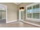 Dining room with wood-look tile, a modern chandelier, and views of the property's landscaping at 2743 Verandah Vue Way, Lakeland, FL 33812
