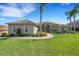 Charming single-story home featuring lush landscaping, a circular driveway, and a welcoming front entrance at 2743 Verandah Vue Way, Lakeland, FL 33812
