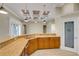 Kitchen bar featuring granite countertops, wood cabinets and access to a pantry at 2743 Verandah Vue Way, Lakeland, FL 33812