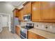 Kitchen with stainless appliances, granite countertops and wood cabinets at 2743 Verandah Vue Way, Lakeland, FL 33812