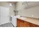 Functional laundry room with washer, dryer, utility sink, and cabinets for storage at 2743 Verandah Vue Way, Lakeland, FL 33812