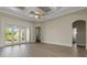 Open living space with wood tile flooring, coffered ceiling and access to lanai at 2743 Verandah Vue Way, Lakeland, FL 33812