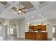 Open-concept living room showcasing coffered ceiling, kitchen bar, and stylish fixtures at 2743 Verandah Vue Way, Lakeland, FL 33812