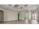 Open living room with coffered ceiling, fan and glass doors to the patio at 2743 Verandah Vue Way, Lakeland, FL 33812