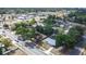 Real estate aerial view of a neighborhood with mature trees and homes near a main thoroughfare and businesses at 280 W Pierce St, Lake Alfred, FL 33850