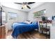 Bright bedroom with a large window, ceiling fan, and wood-look flooring; features a vanity area at 280 W Pierce St, Lake Alfred, FL 33850