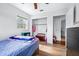 Well-lit bedroom with wood-look flooring, a window, and an open closet with organized storage at 280 W Pierce St, Lake Alfred, FL 33850