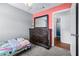 Cozy bedroom featuring a pink accent wall, a dresser with mirror, and carpet floors at 280 W Pierce St, Lake Alfred, FL 33850