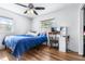 Bright bedroom with a large window, ceiling fan, and wood-look flooring; features a vanity area at 280 W Pierce St, Lake Alfred, FL 33850