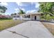 Charming single-story home with a spacious driveway, covered carport, and a well-maintained front yard at 280 W Pierce St, Lake Alfred, FL 33850