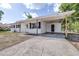 Charming single-story home with a spacious driveway, covered carport, and a classic white exterior at 280 W Pierce St, Lake Alfred, FL 33850