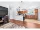 Living room area with hardwood floors and view to the kitchen featuring wood cabinets at 280 W Pierce St, Lake Alfred, FL 33850