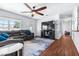Inviting living room featuring wood floors, ceiling fan, natural light, and comfortable seating at 280 W Pierce St, Lake Alfred, FL 33850