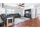 Inviting living room with hardwood floors, a ceiling fan, a plush sofa, and natural light at 280 W Pierce St, Lake Alfred, FL 33850