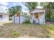 Outdoor storage with both metal and wooden sheds with fenced in yard at 280 W Pierce St, Lake Alfred, FL 33850