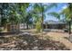 A view of the backyard including a shed and screened-in pool area, surrounded by mature trees at 2933 Blackwater Oaks Dr, Mulberry, FL 33860