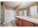 Bathroom featuring double sinks, a large mirror, and a shower/tub combo at 2933 Blackwater Oaks Dr, Mulberry, FL 33860