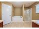Bright bathroom featuring a separate tub and glass-enclosed shower at 2933 Blackwater Oaks Dr, Mulberry, FL 33860