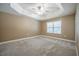 Bedroom featuring neutral walls, ceiling fan, plush carpeting and tray ceiling at 2933 Blackwater Oaks Dr, Mulberry, FL 33860