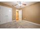 Bedroom with a ceiling fan, plush carpet, and a double door closet at 2933 Blackwater Oaks Dr, Mulberry, FL 33860