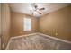 Cozy bedroom with neutral walls, ceiling fan and soft patterned carpeting at 2933 Blackwater Oaks Dr, Mulberry, FL 33860