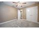 Bedroom with a ceiling fan, plush carpeting and a double door closet at 2933 Blackwater Oaks Dr, Mulberry, FL 33860