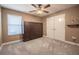 Well-lit bedroom with neutral tones, carpeting, and closet at 2933 Blackwater Oaks Dr, Mulberry, FL 33860