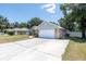 Side view of brick house featuring a driveway and two-car garage at 2933 Blackwater Oaks Dr, Mulberry, FL 33860