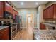 Modern kitchen with stainless steel appliances, dark cabinets, and granite countertops at 2933 Blackwater Oaks Dr, Mulberry, FL 33860