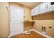 Laundry room with white cabinets, a folding counter, and a laundry sink at 2933 Blackwater Oaks Dr, Mulberry, FL 33860