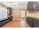 Spacious living room featuring laminate flooring, ceiling fan, and built-in storage cabinets at 2933 Blackwater Oaks Dr, Mulberry, FL 33860