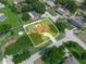 Aerial view of a residential property showcasing the house, yard, pool, driveway, and surrounding neighborhood at 3002 Helms Dr, Auburndale, FL 33823