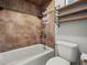 This is a bathroom with a white tub and decorative tiled wall at 3002 Helms Dr, Auburndale, FL 33823