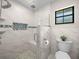 Tiled bathroom features a modern shower with rainfall head and built-in niche at 3002 Helms Dr, Auburndale, FL 33823