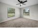 Bright bedroom featuring neutral carpet, ceiling fan and windows with blinds at 3002 Helms Dr, Auburndale, FL 33823